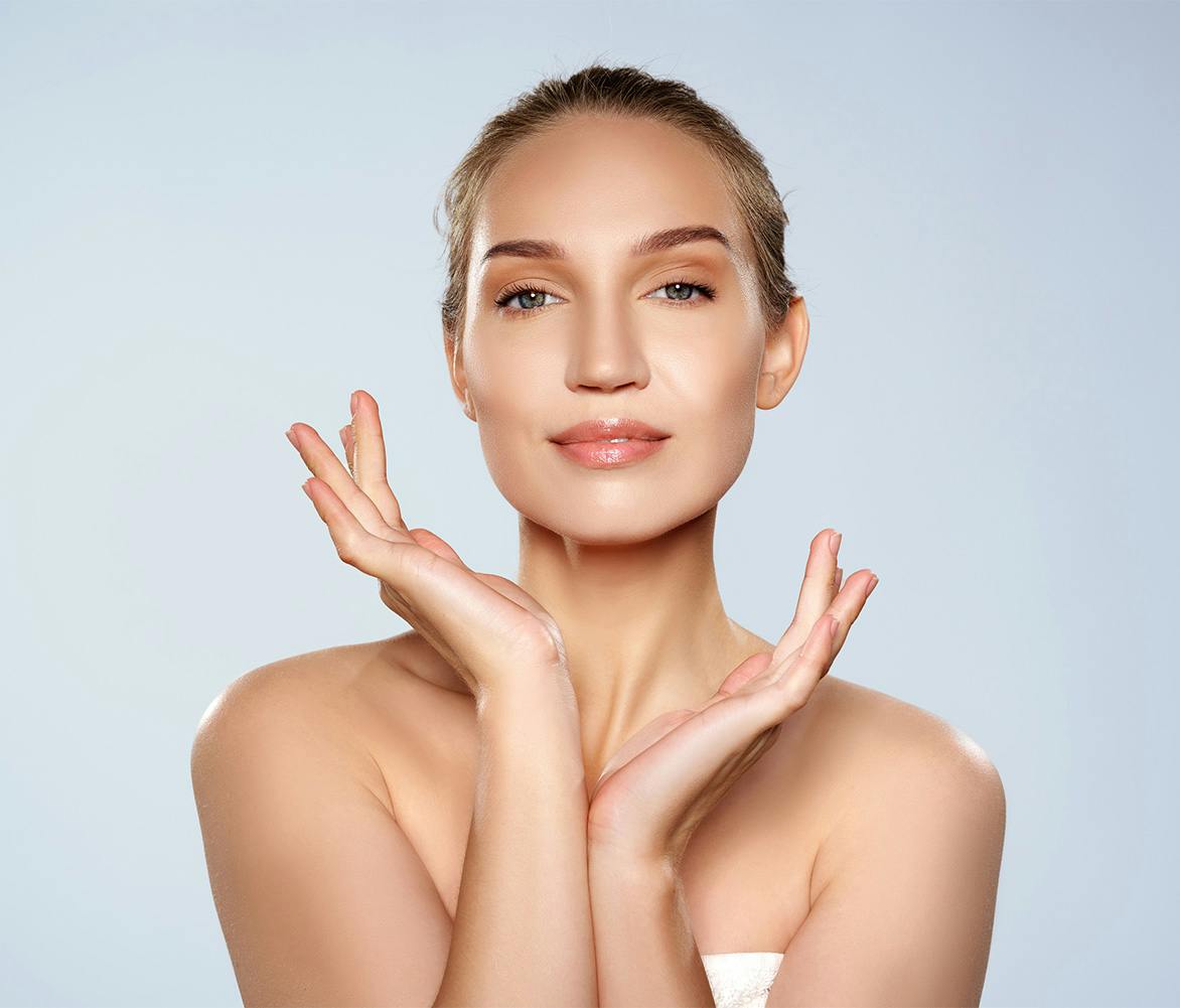 woman with hands under her face