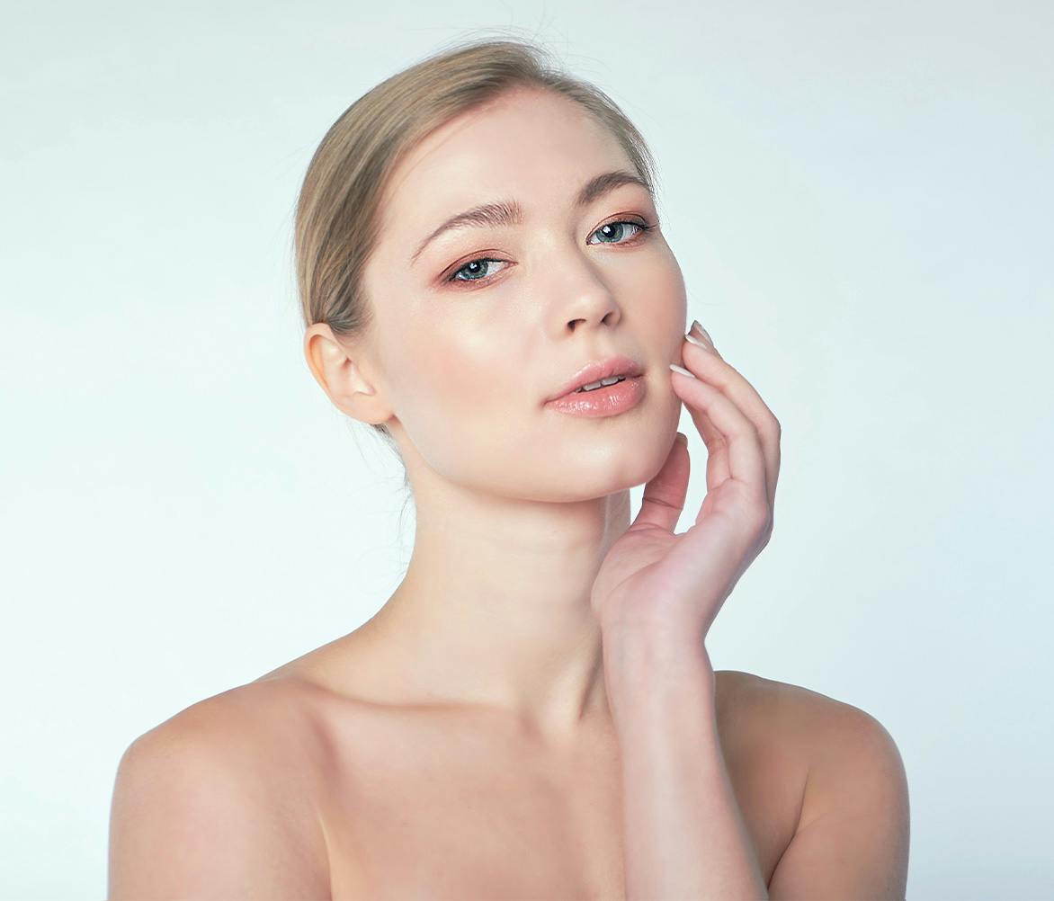 woman touching her face