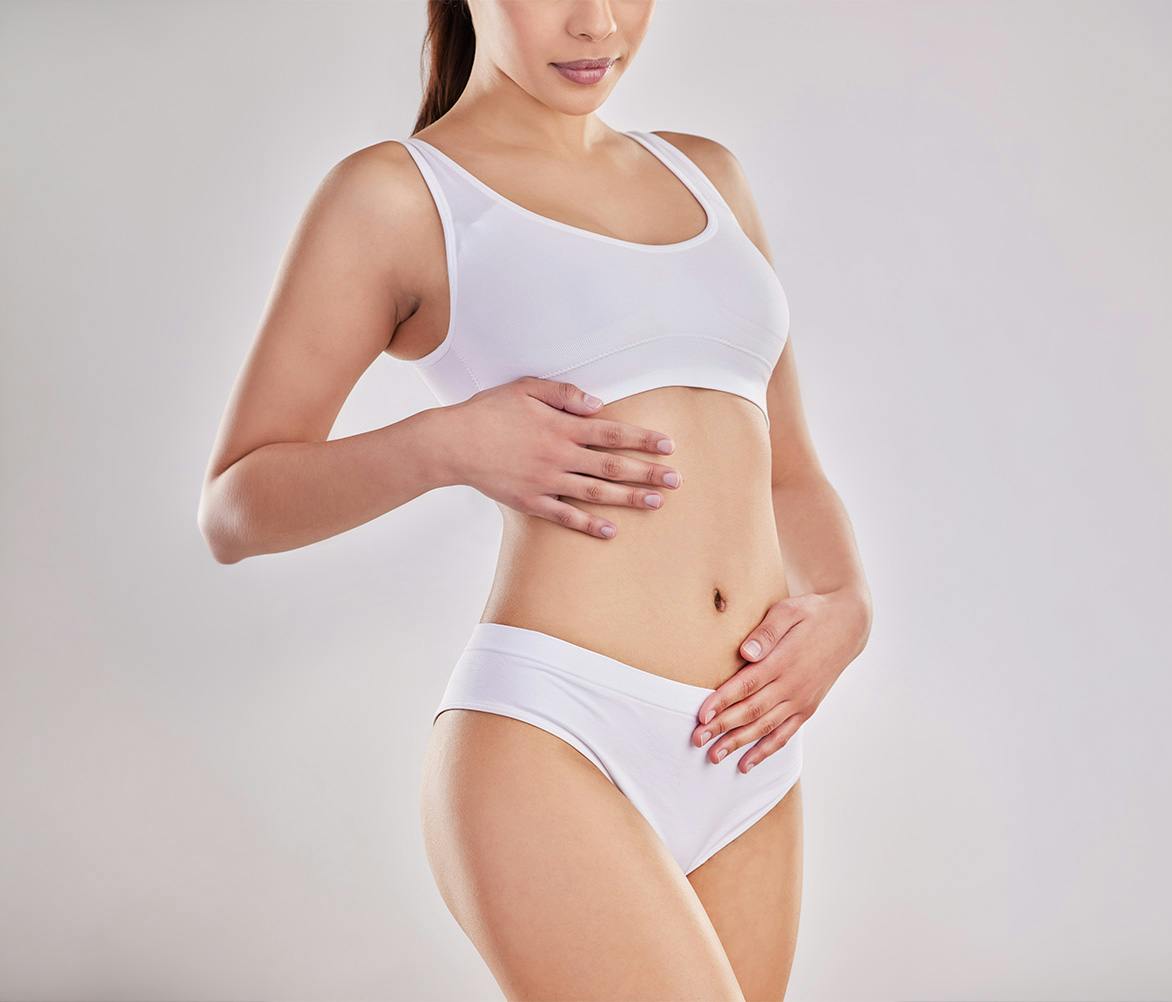 women standing with hands on tummy