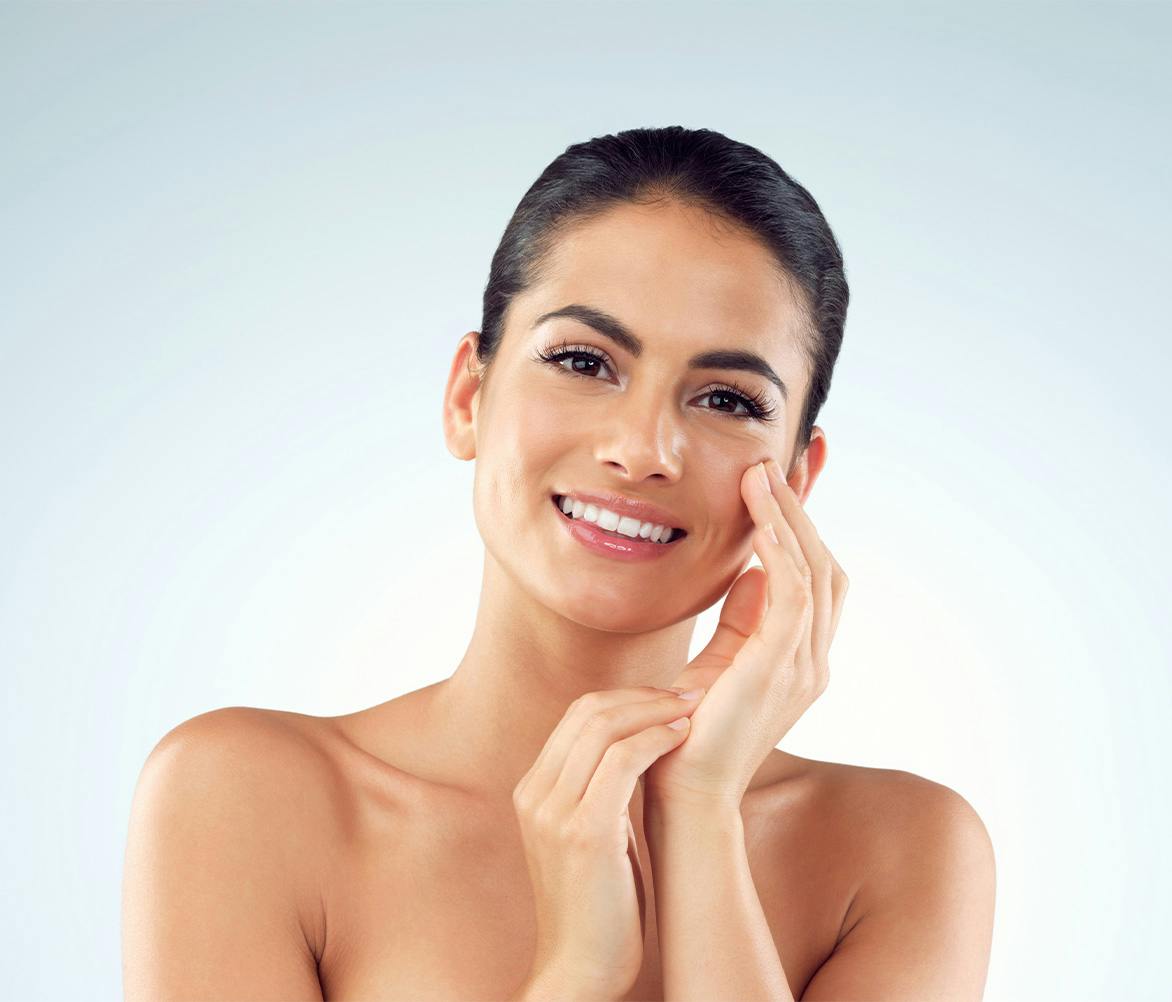 women smiling touching her cheek