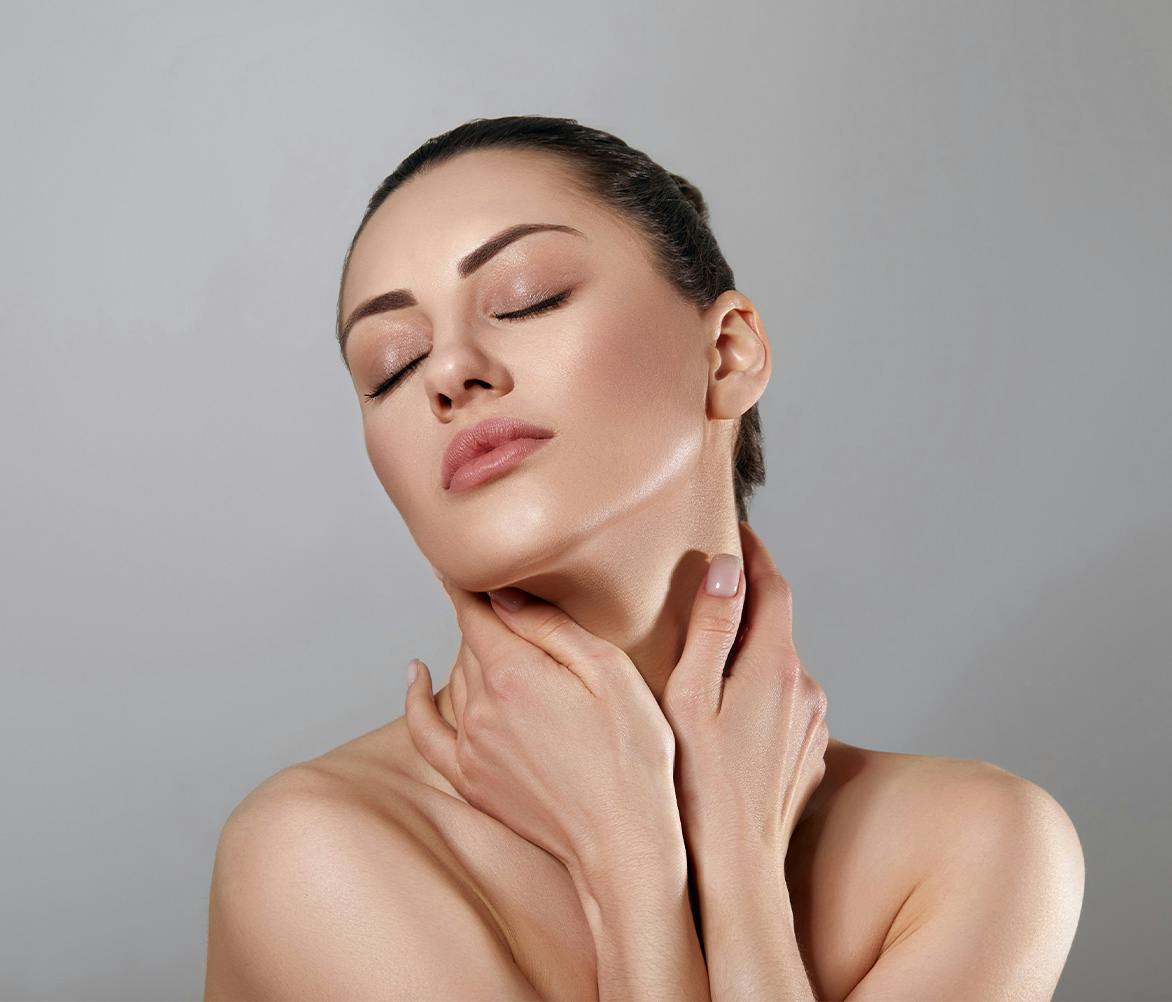 women with hands on neck
