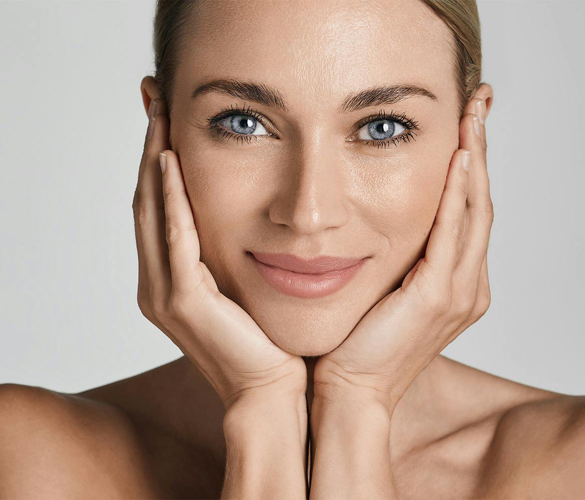woman with both hands on face