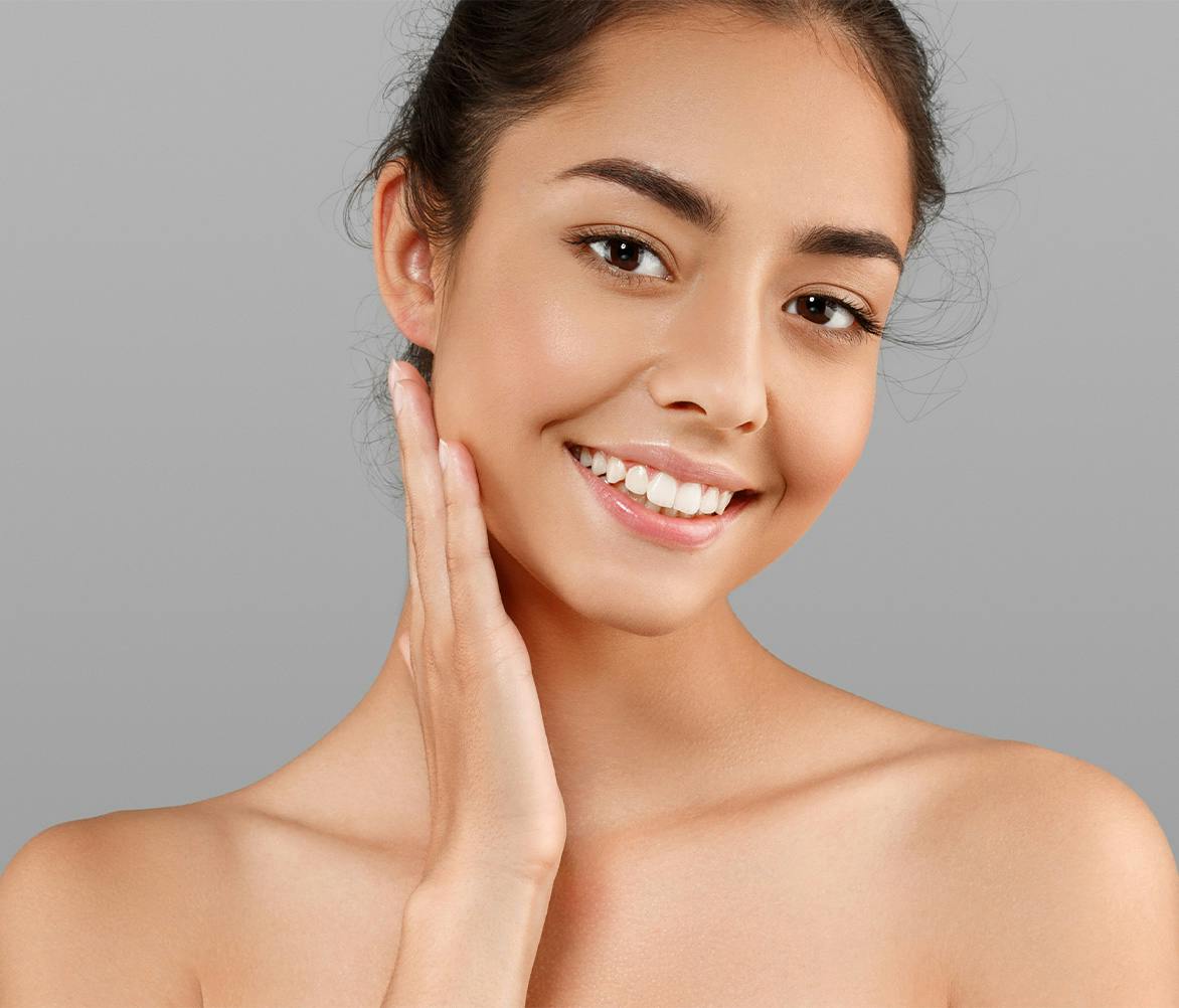 woman smiling touching cheek