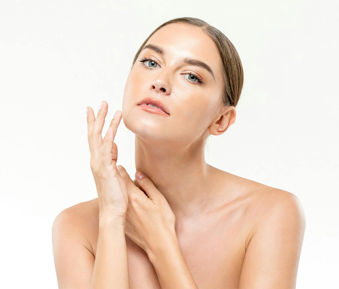 woman touching her face and neck