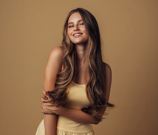 woman smiling holding her arm