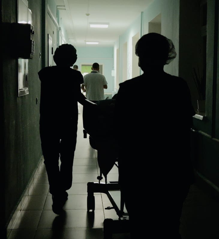 people walking through a hallway at the hospital