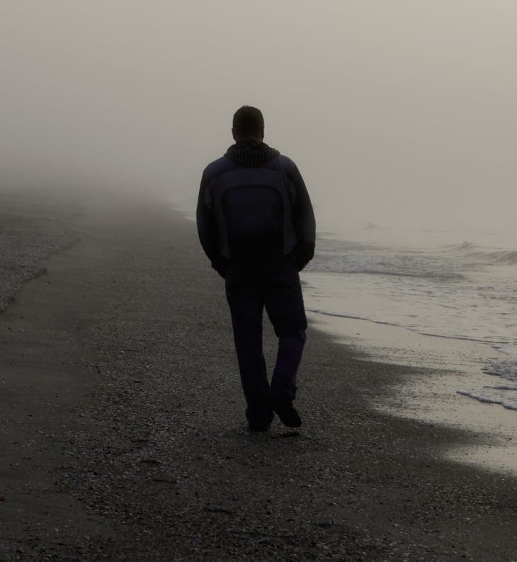 person walking at the beach