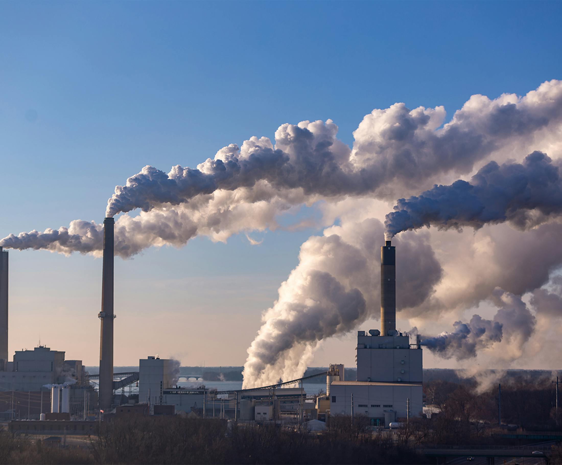 Factory smokestacks releasing emissions into the atmosphere