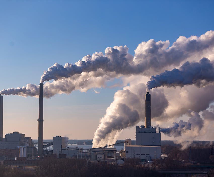 Factory smokestacks releasing emissions into the atmosphere
