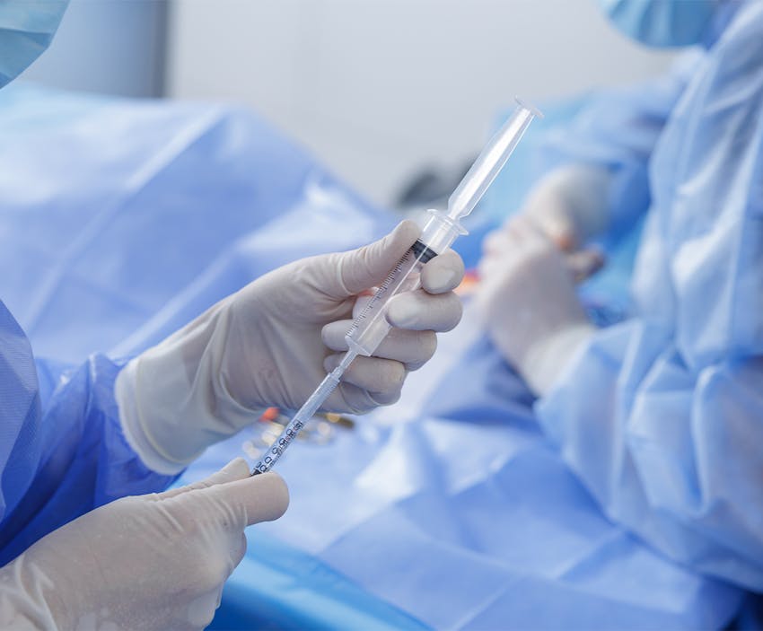 doctor filling a syringe