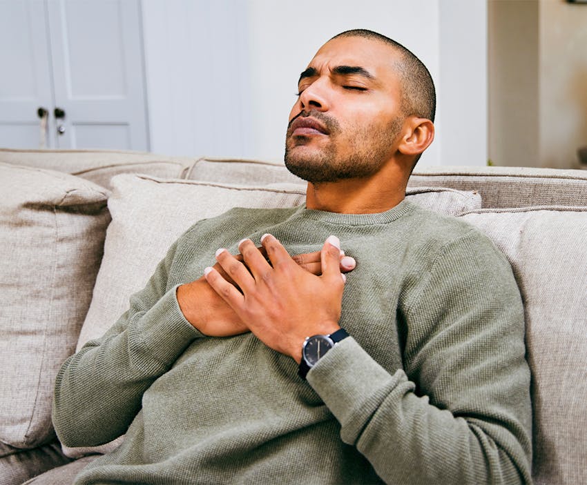 man clutching his chest