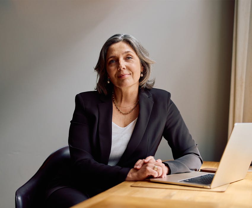 woman leaning on a desk