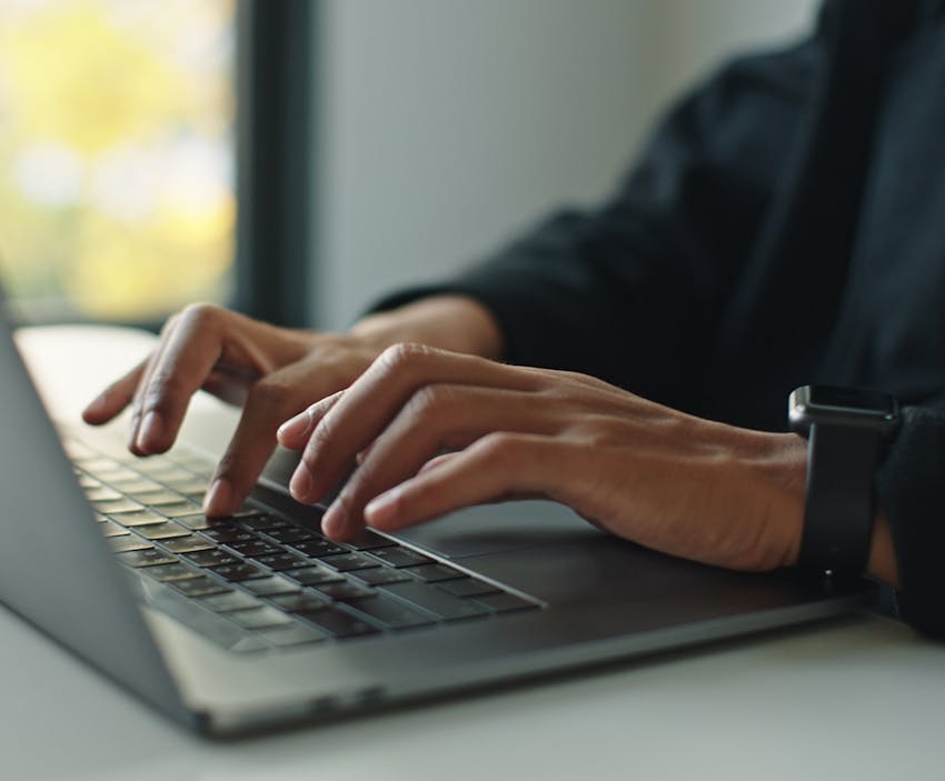 person tying on a computer