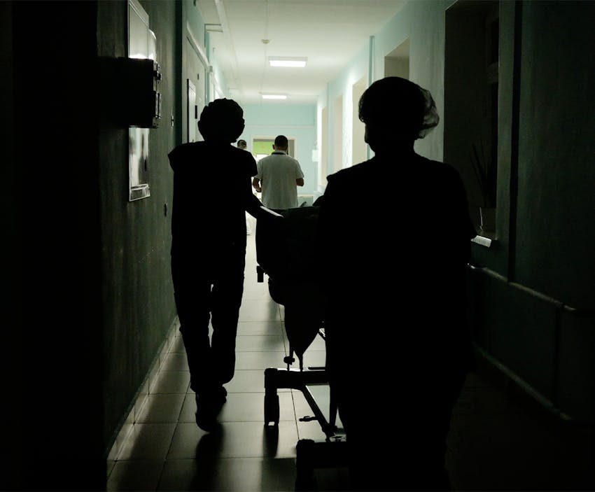 nurses walking a gurney down a gall