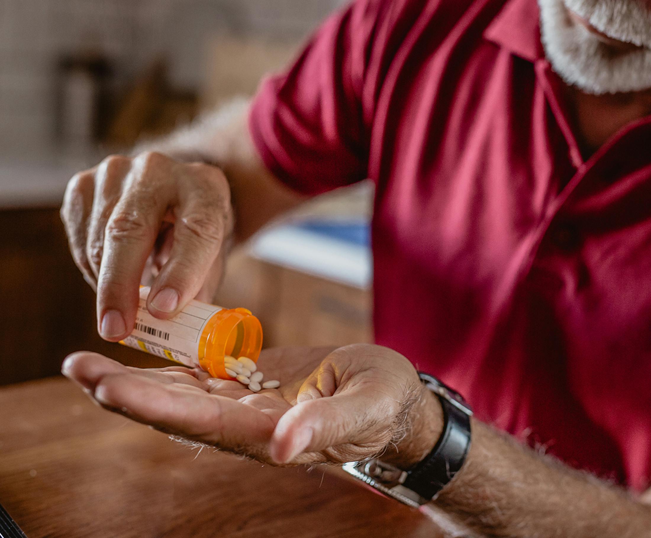 man pouring pills into his hand