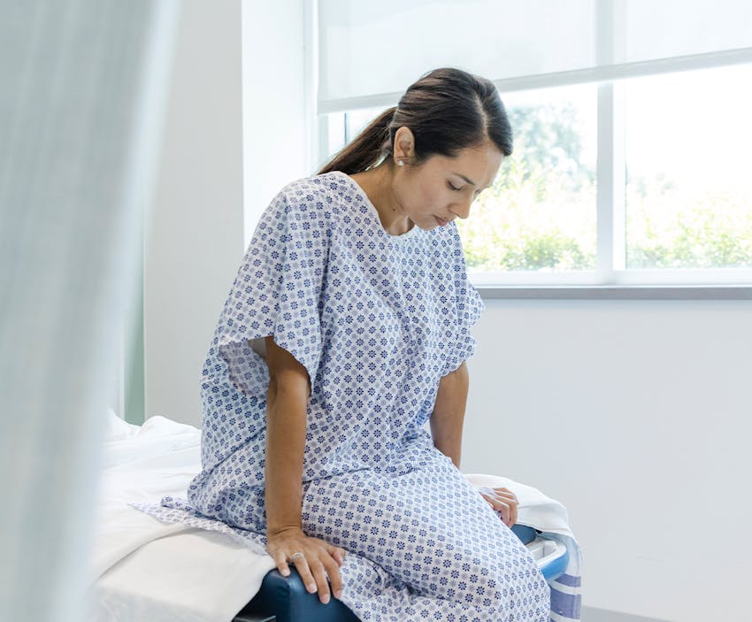 woman sitting on a hospital bed