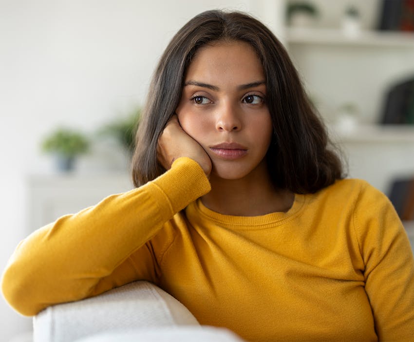 woman leaning her head on her hand