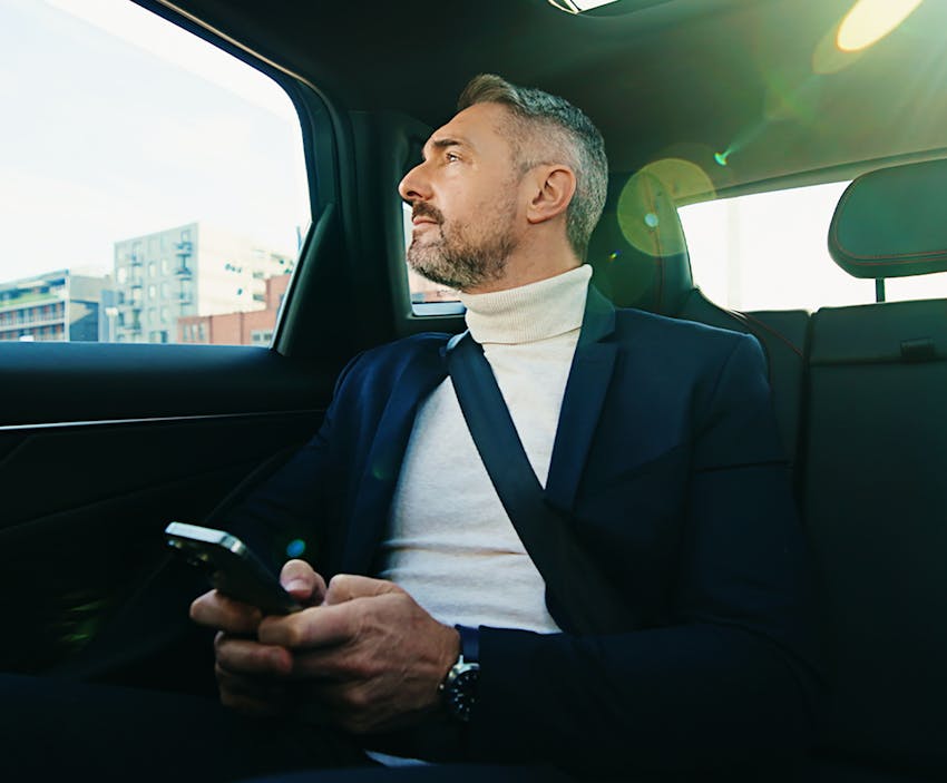 Man looking out car window