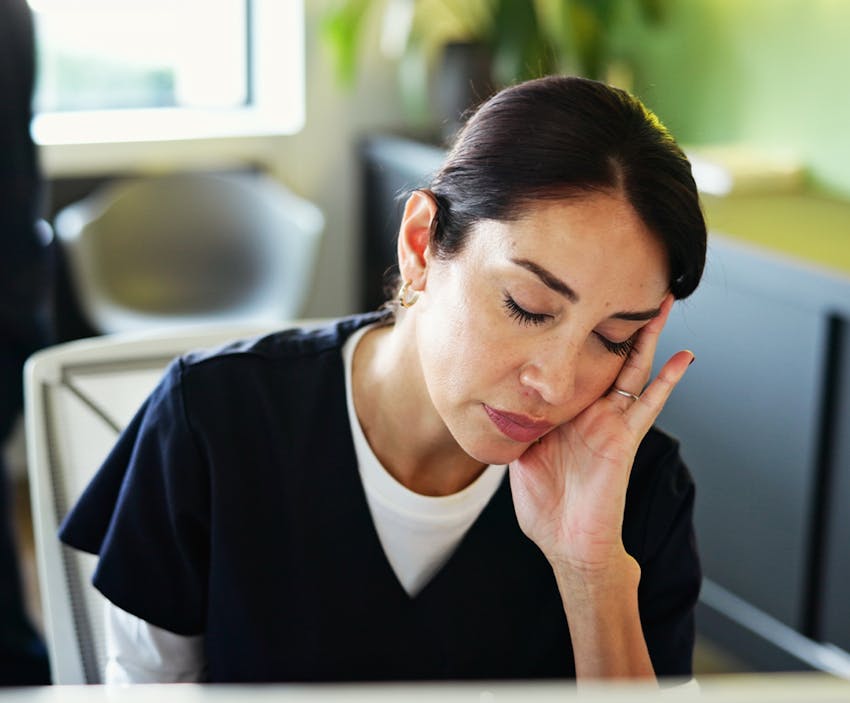 woman leaning her head on her hand
