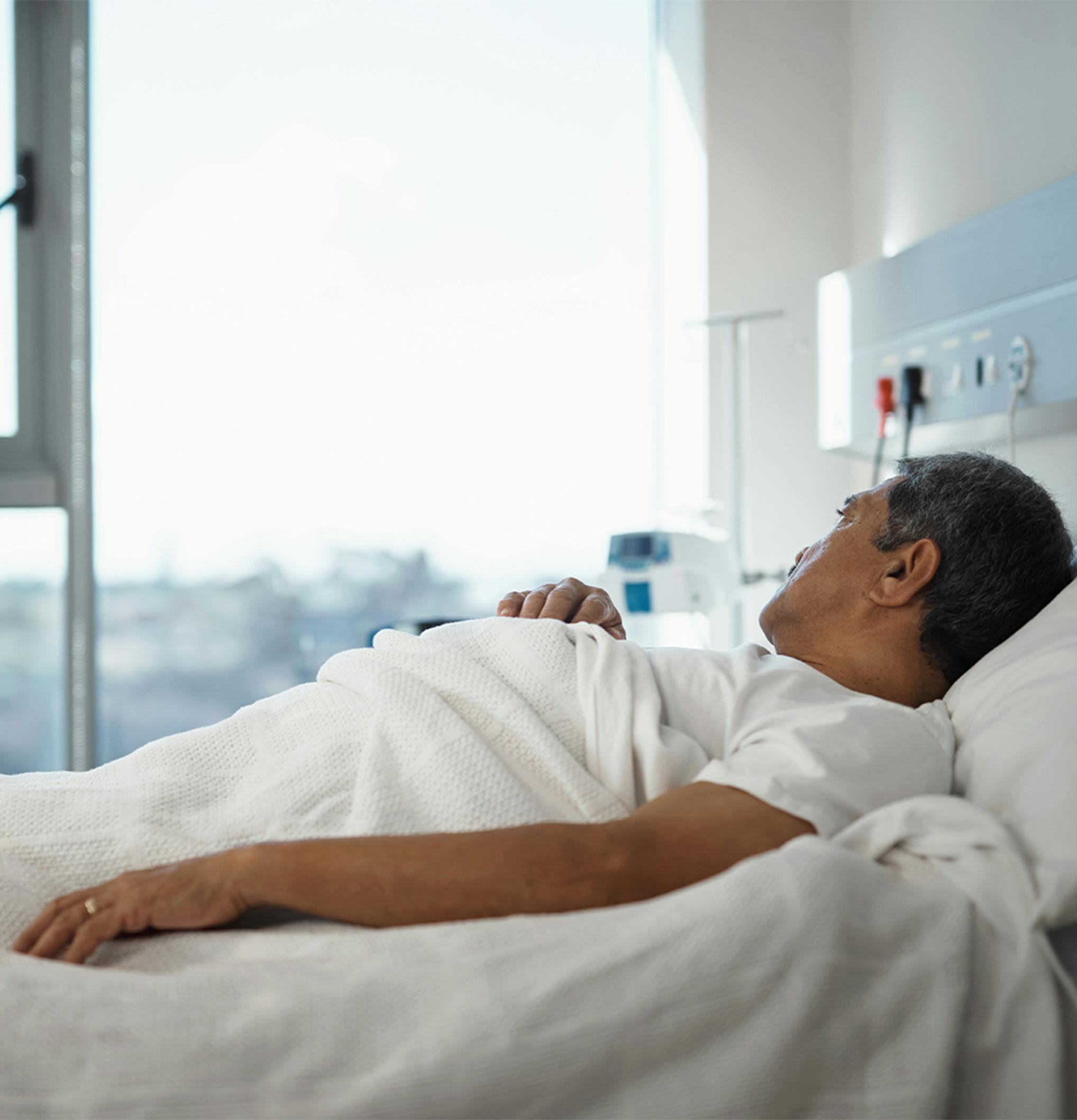 man laying in a hospital bed