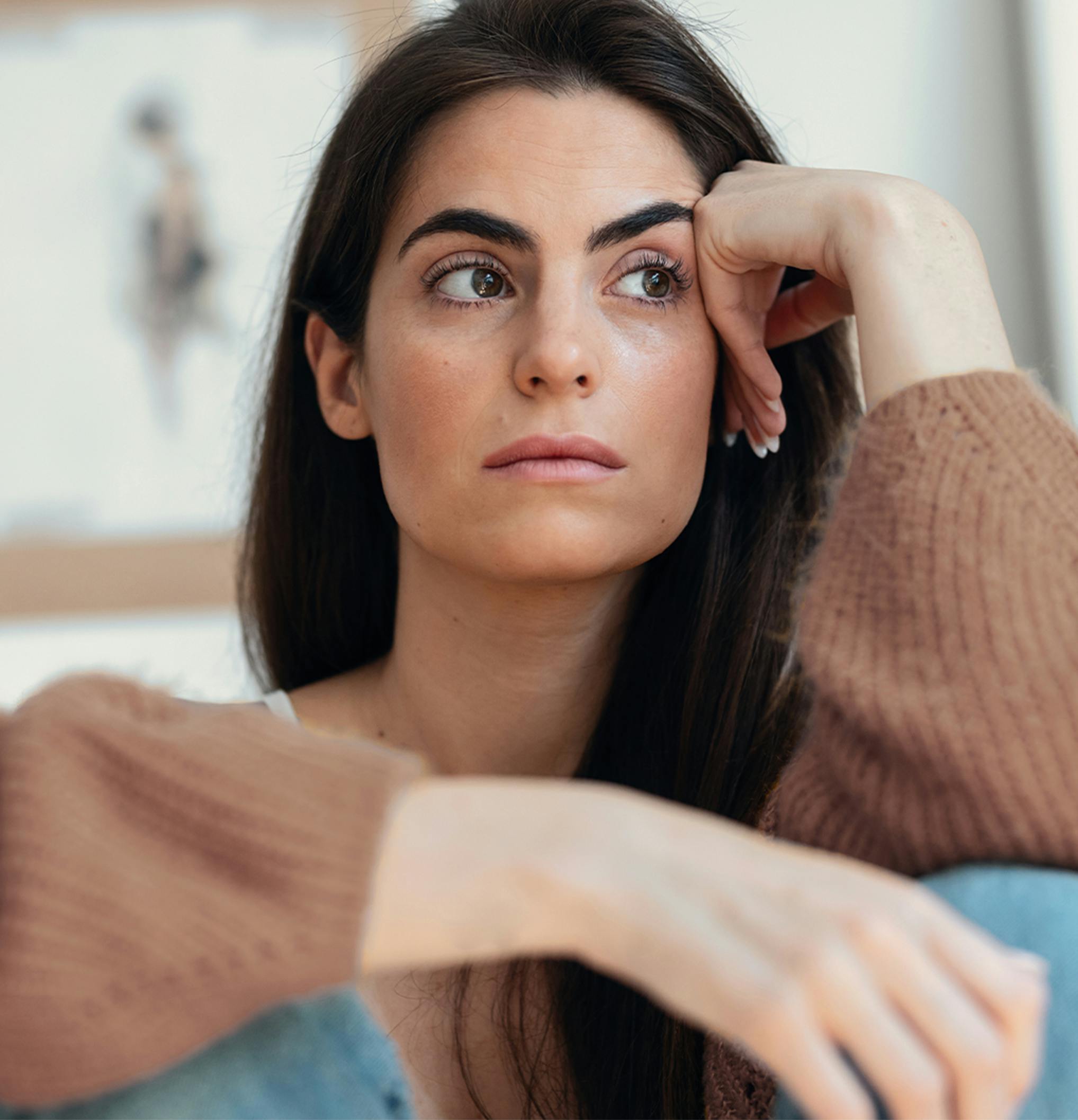 woman leaning her head on her hand