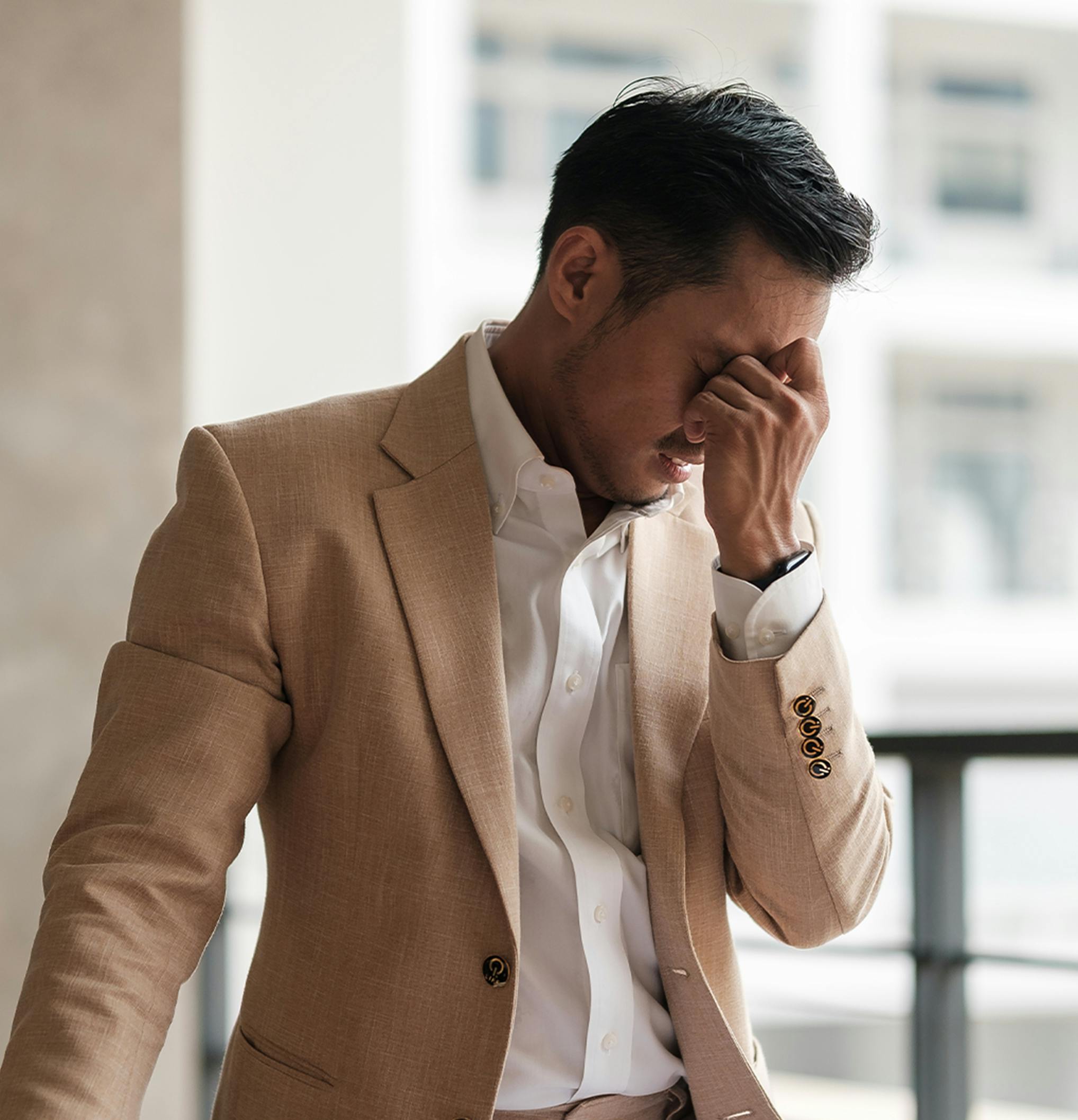 man holding his head in his hand