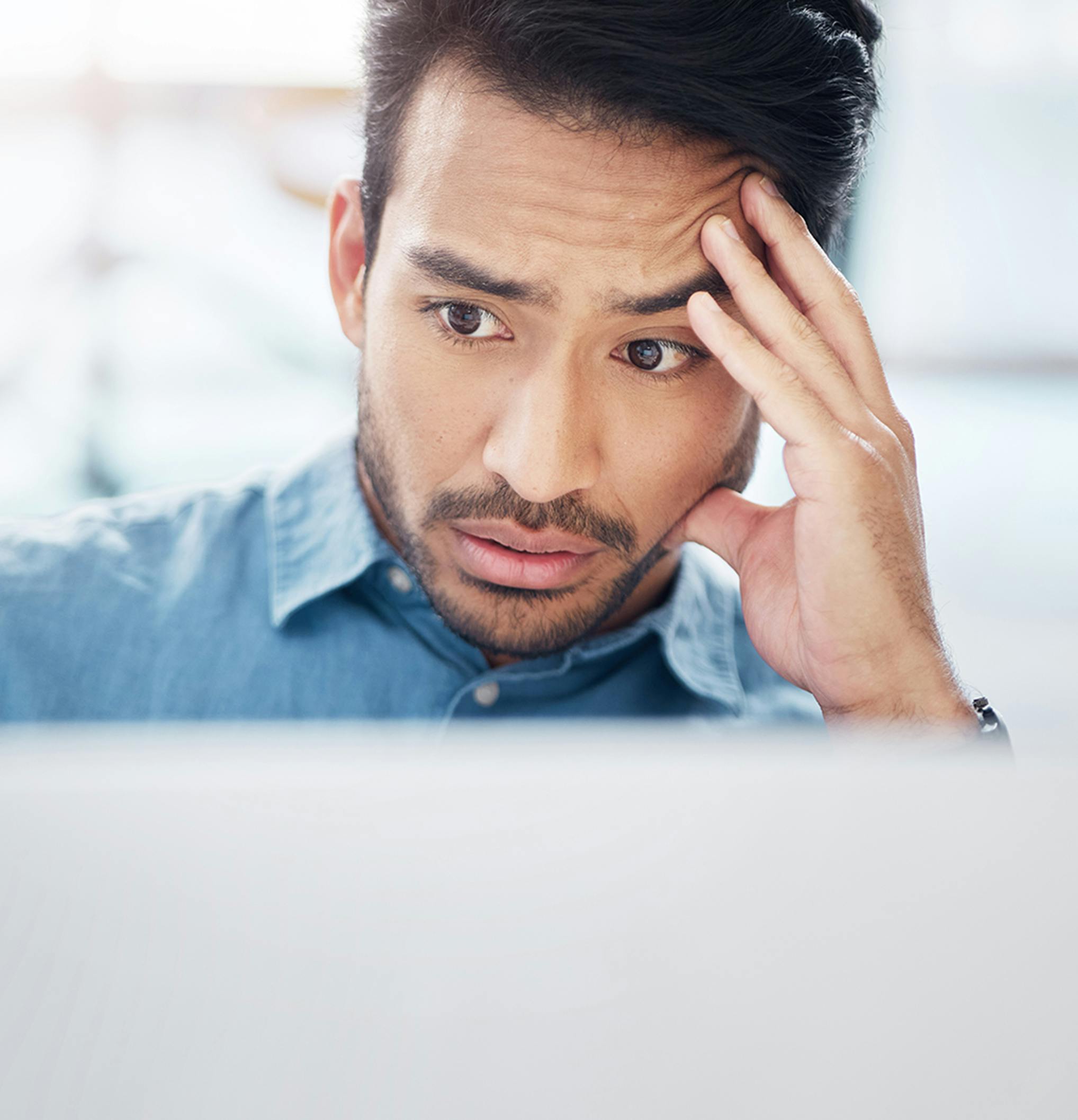 stressed man looking at his computer