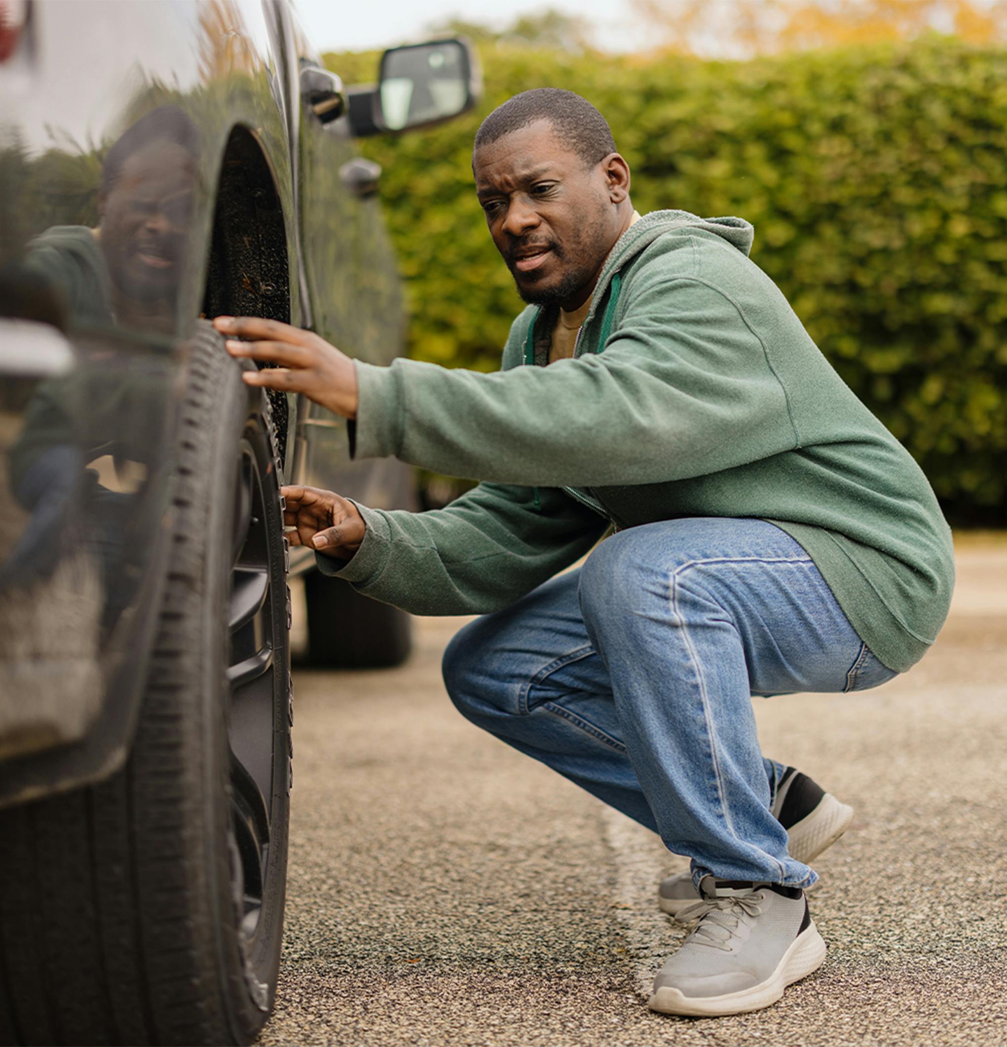 Man looking at a tire