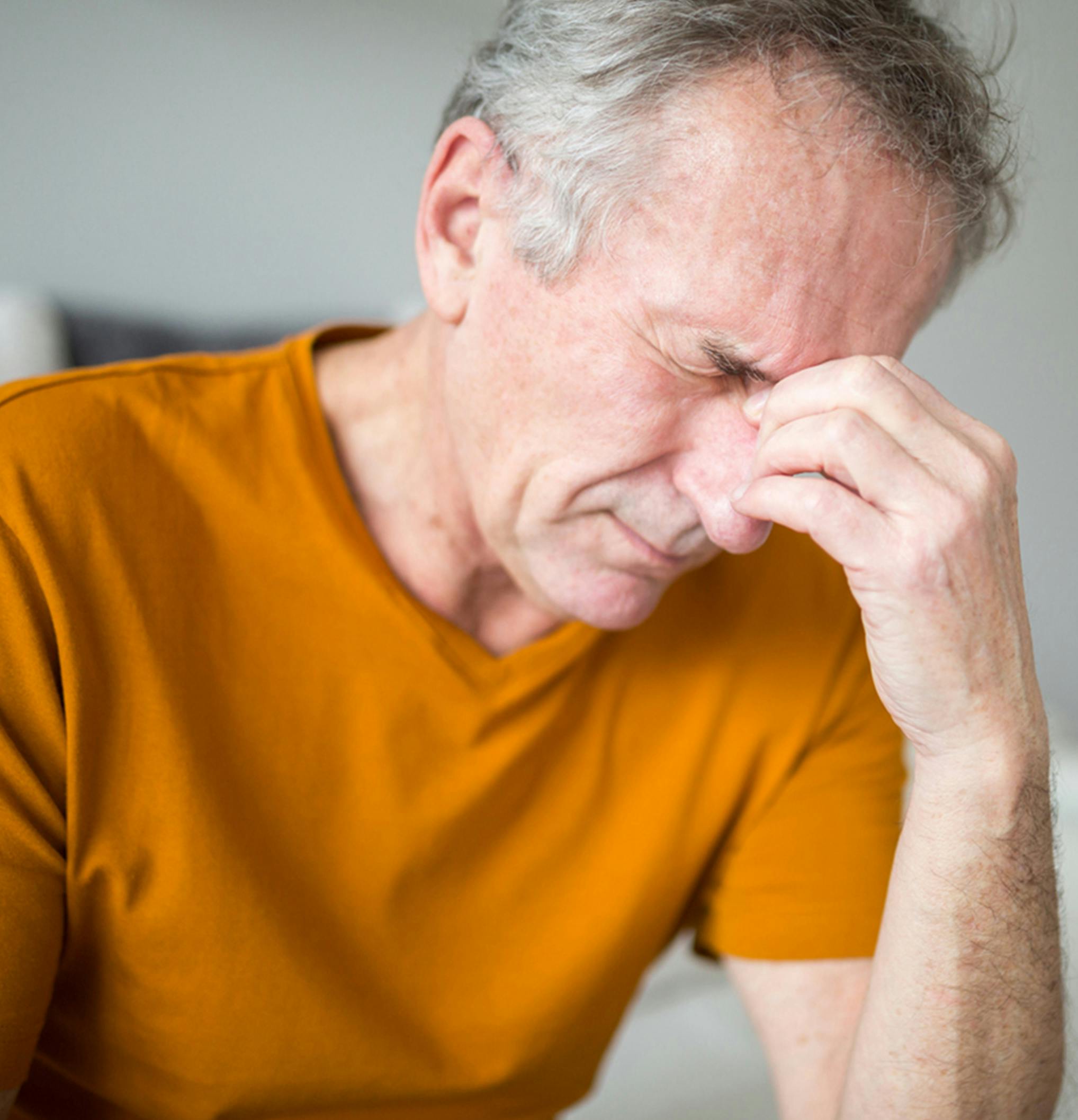 man holding the bridge of his nose