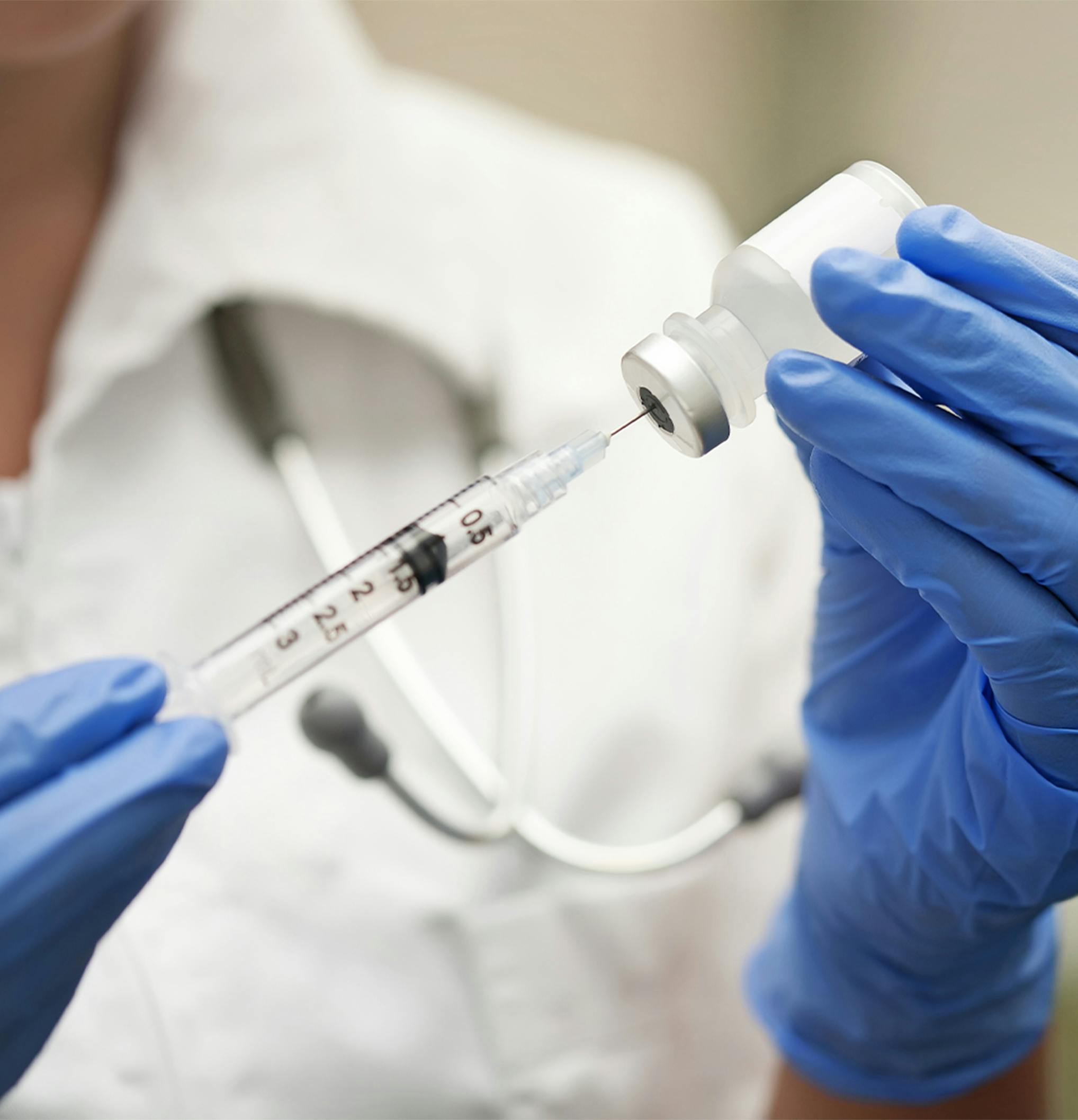 doctor filling a syringe