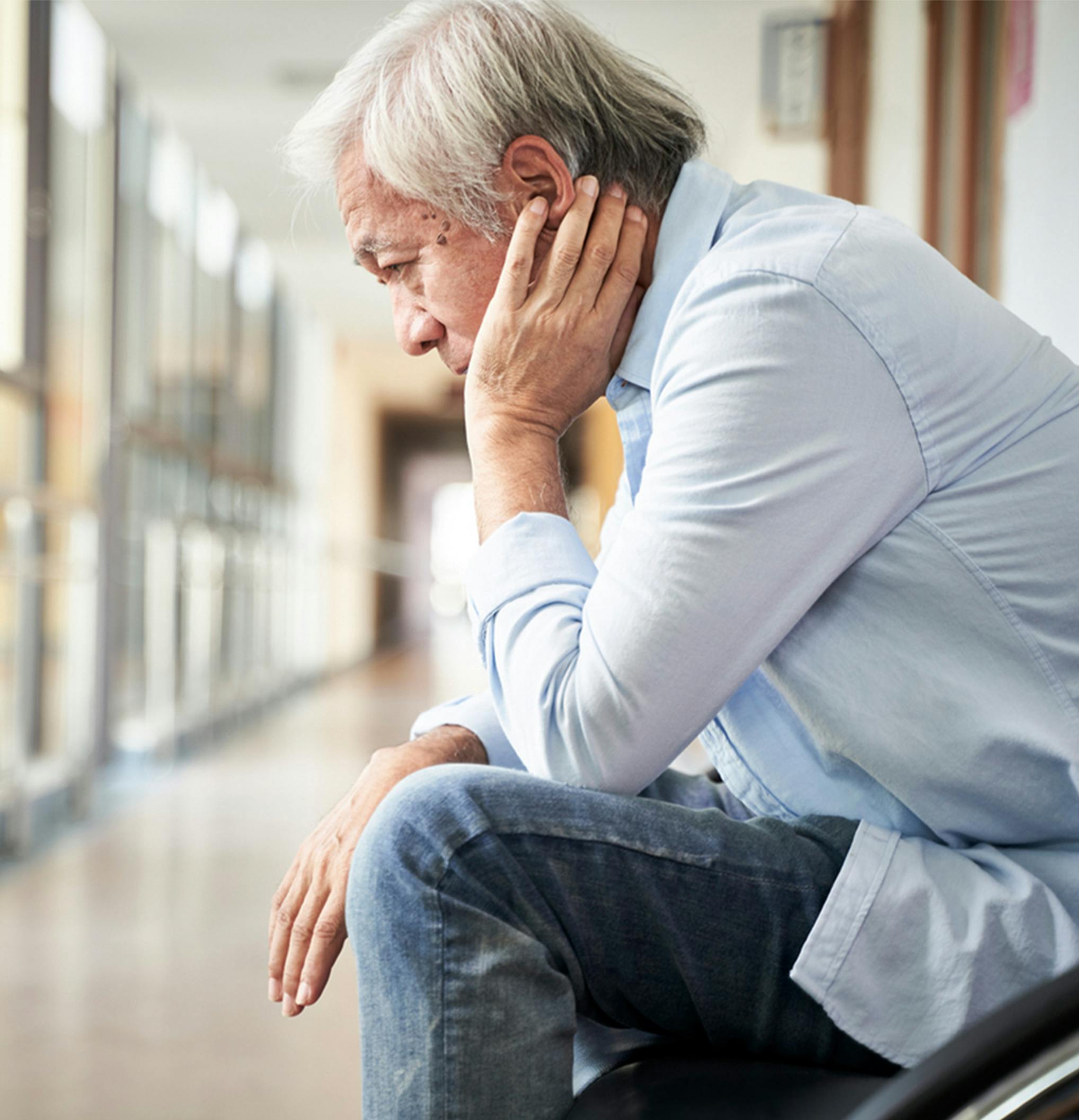 man sitting outside of a hospital room