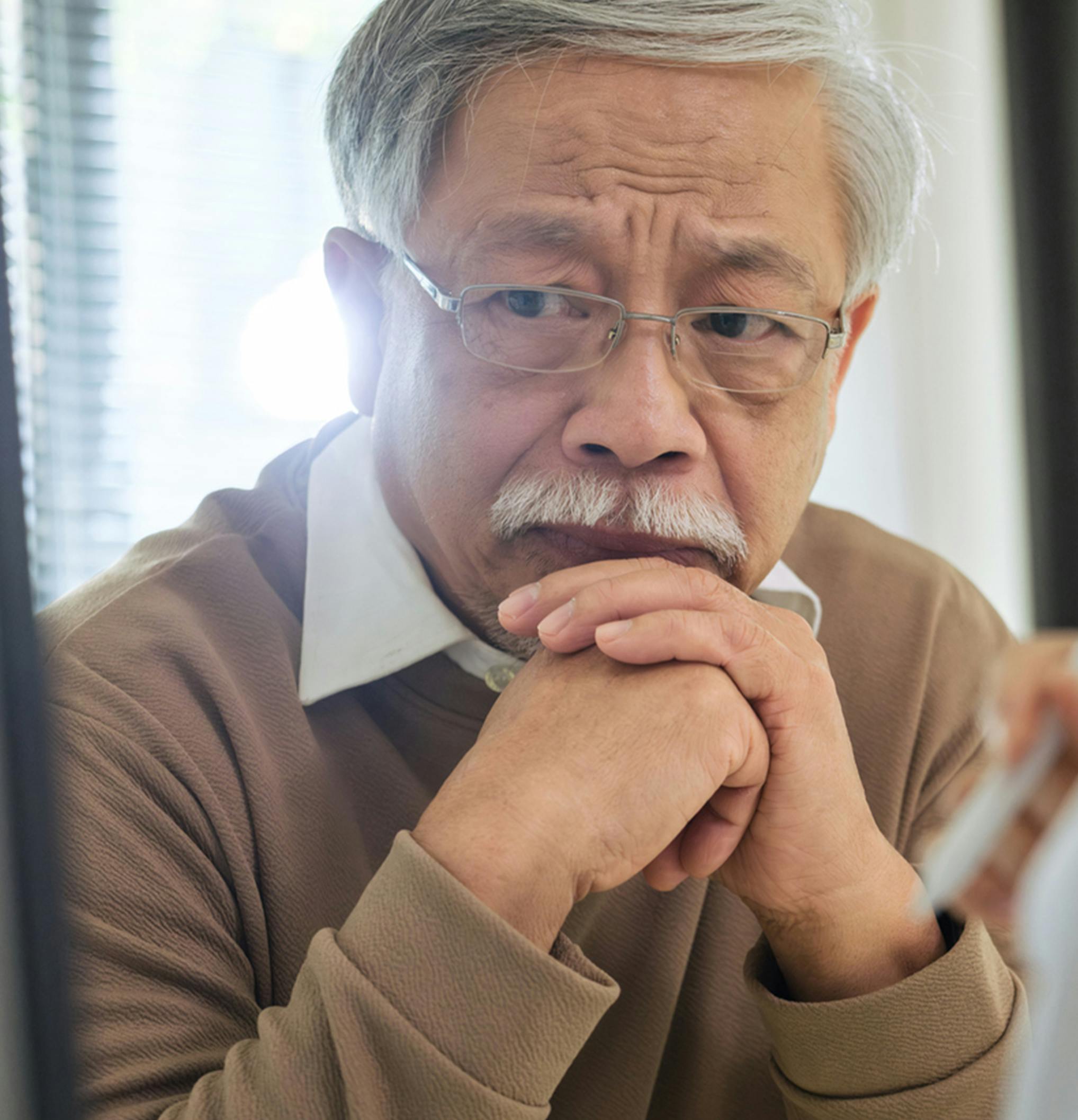 Older man looking sad