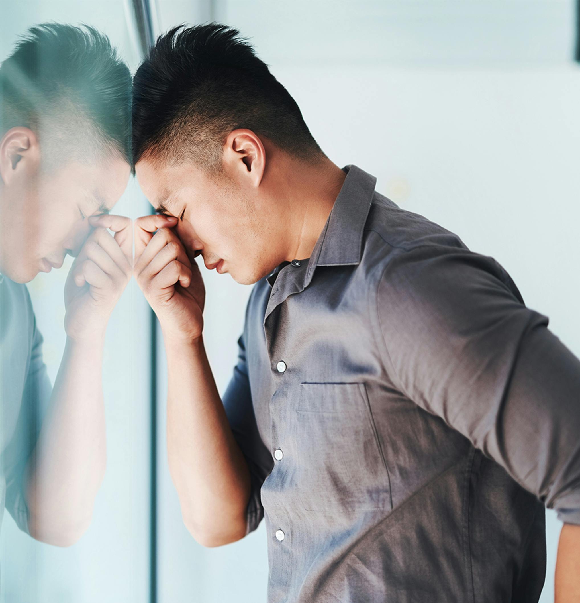 man pinching the bridge of his nose