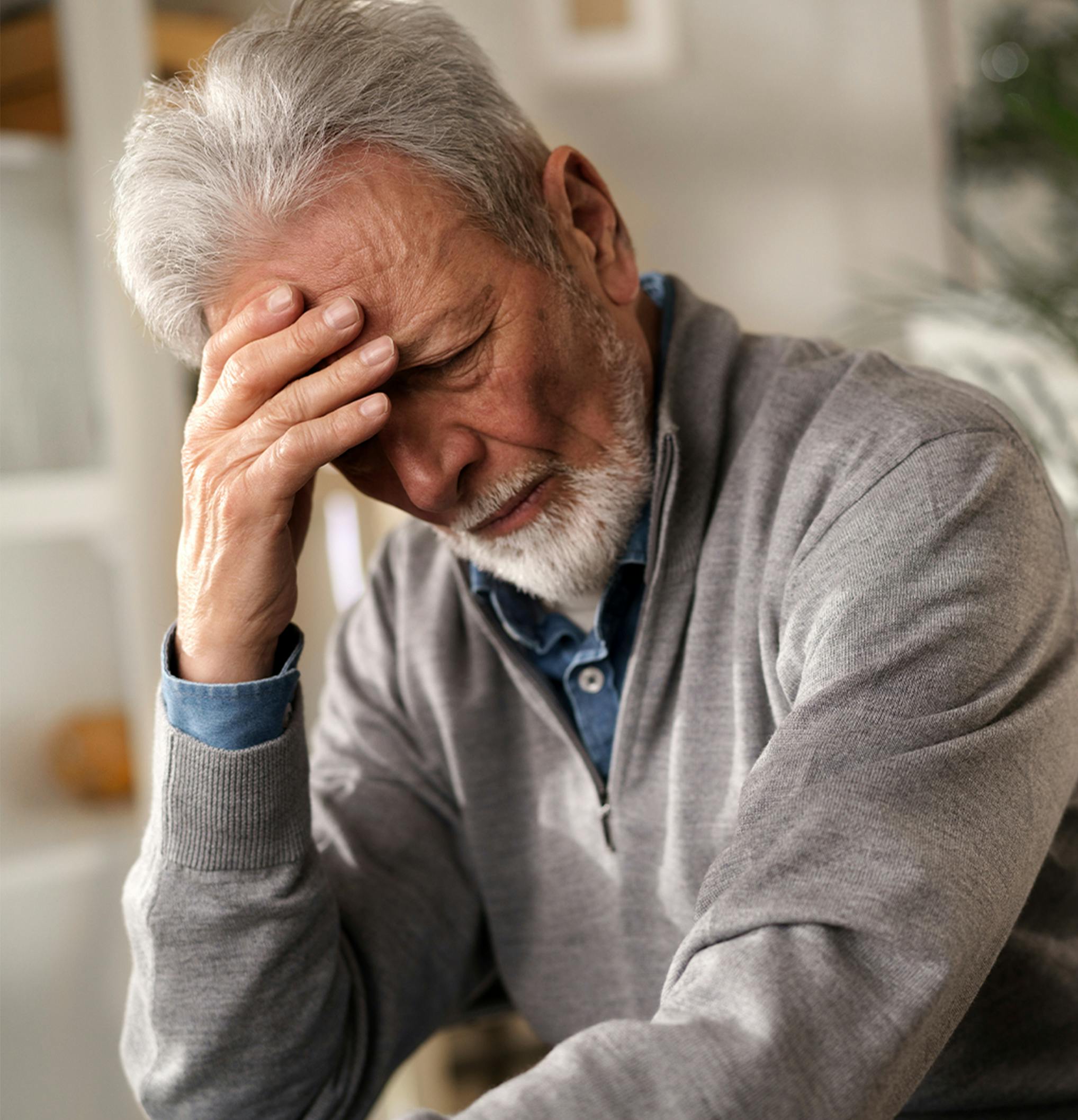 man holding his head in his hand