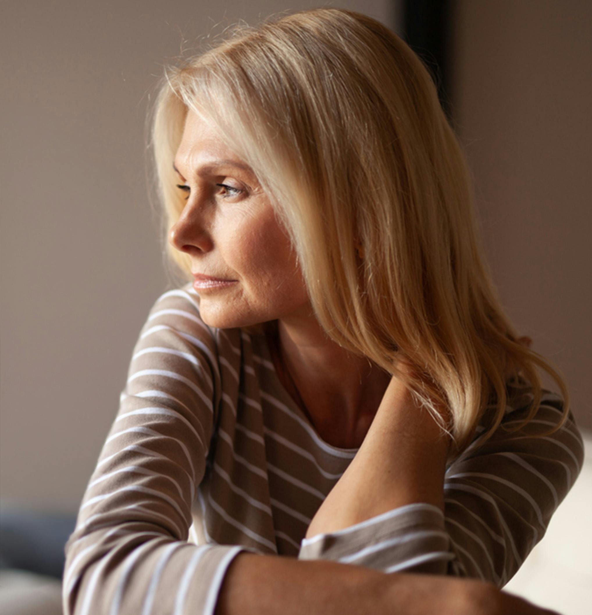 woman holding the back of her neck