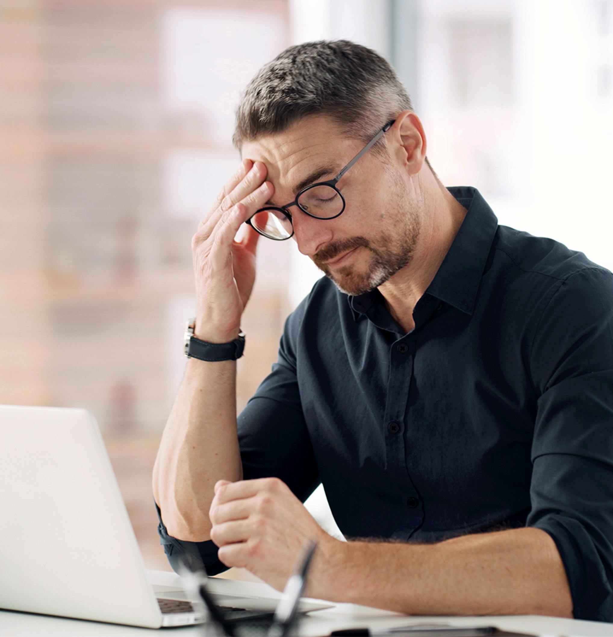 man leaning his head on his hand