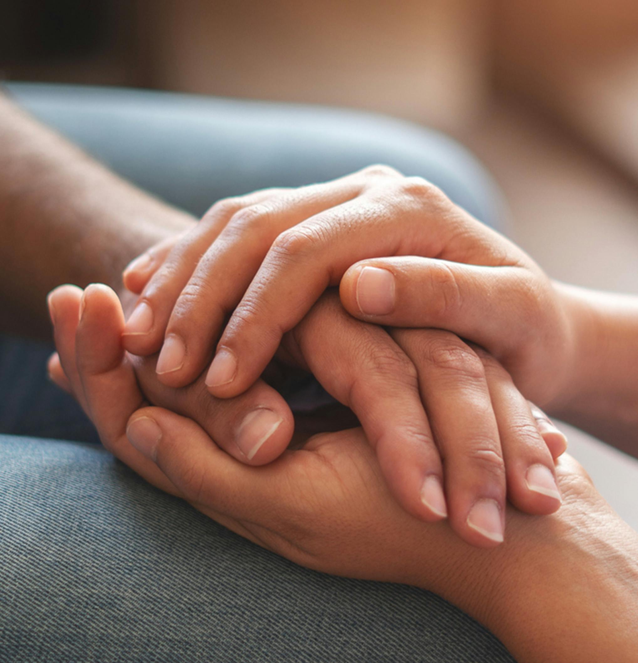 person holding another persons hand between their own