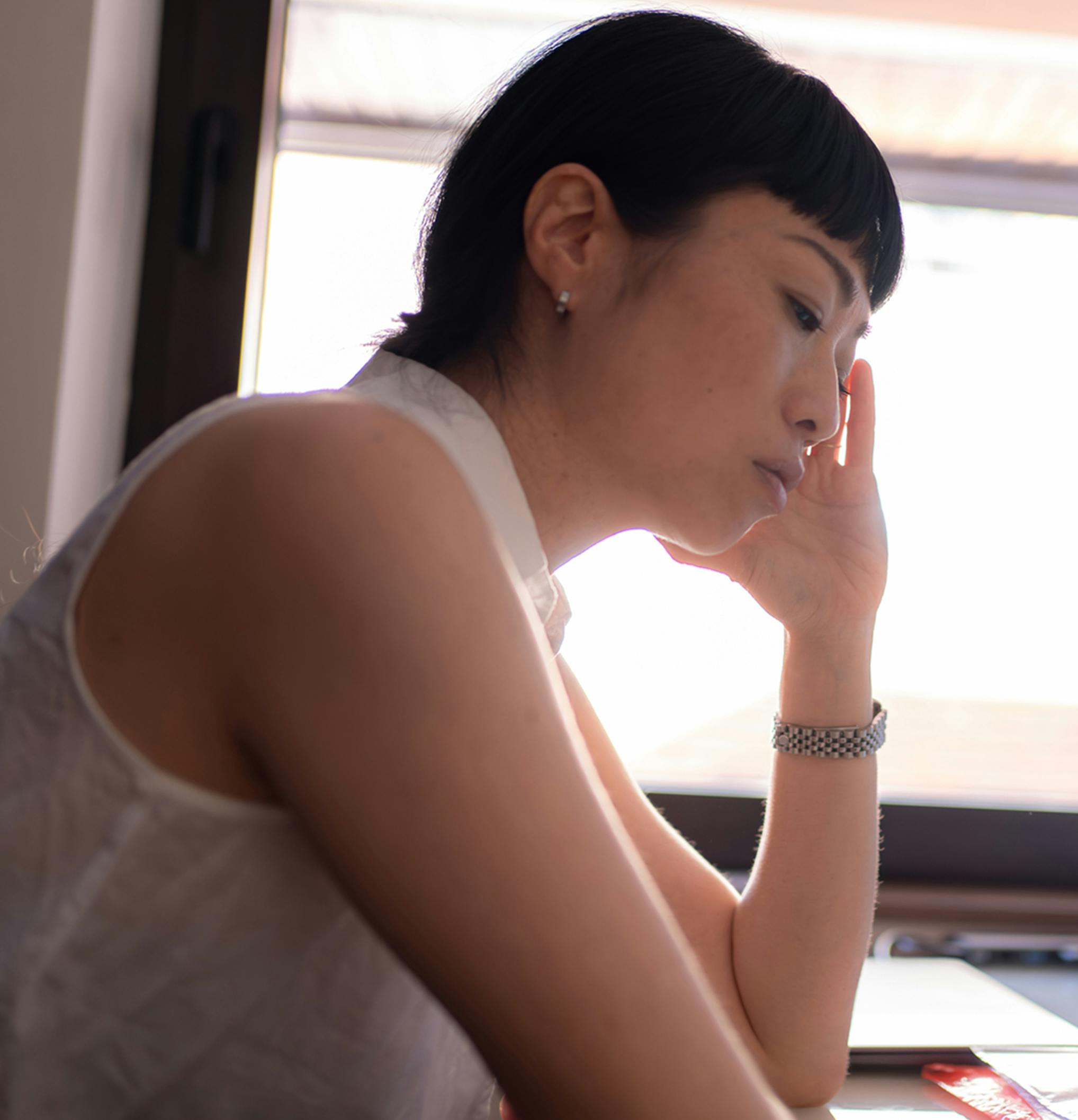 woman leaning her head on her hand