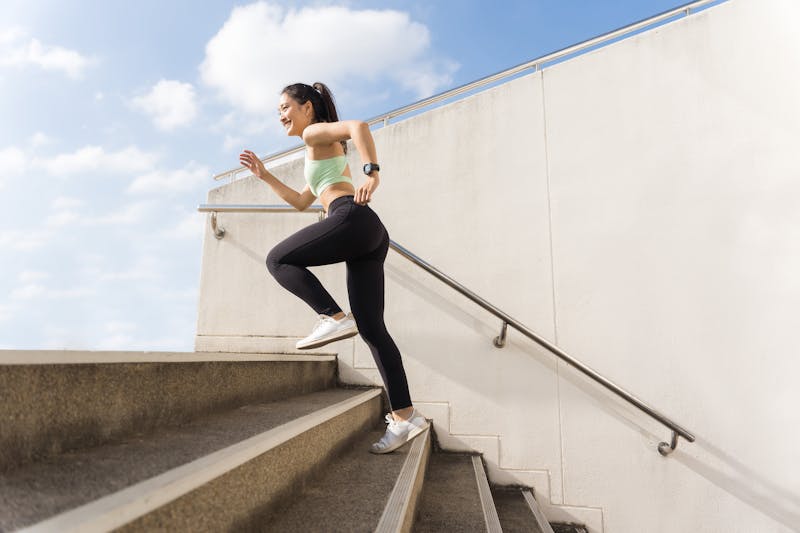 woman exercising running up stairs