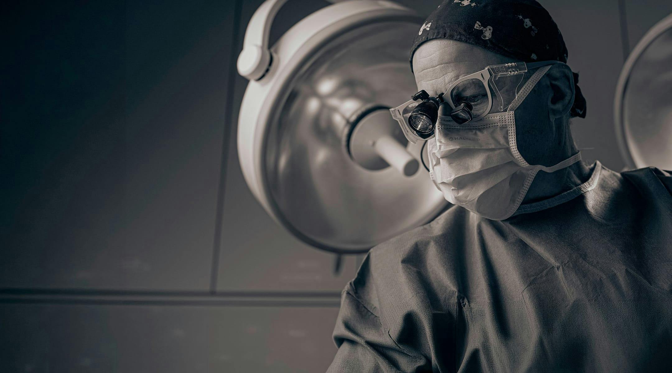 Dr. Jonathan Berman in surgical scrubs and mask
