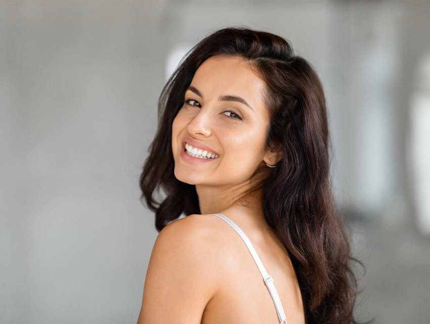 woman smiling over her shoulder