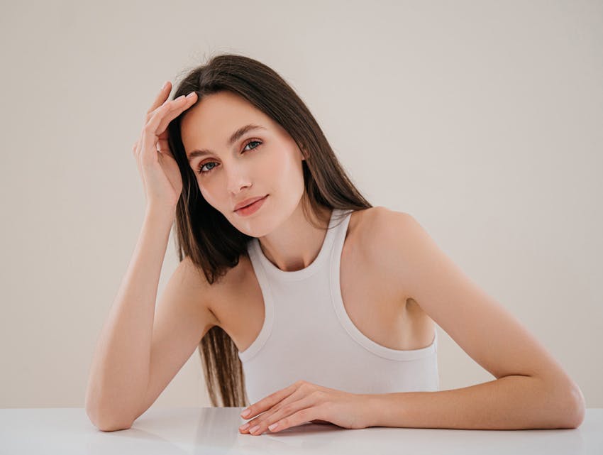 woman leaning her head on her hand