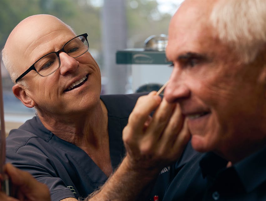 doctor examining a patient's face