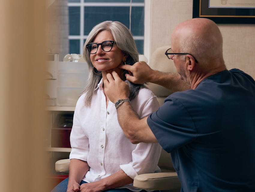 doctor examining a patient's neck