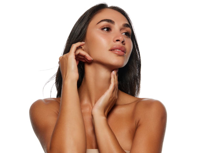 woman touching her face and neck