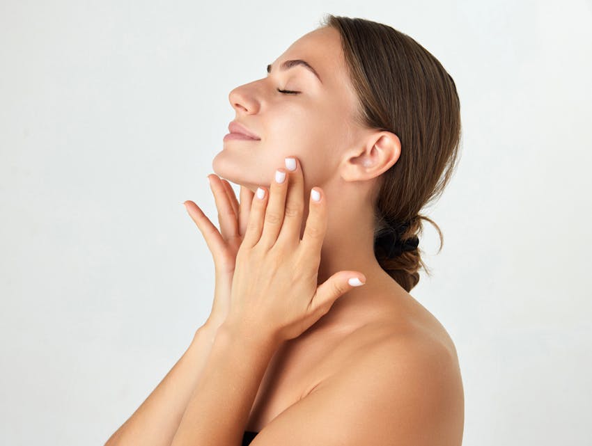 woman touching her neck