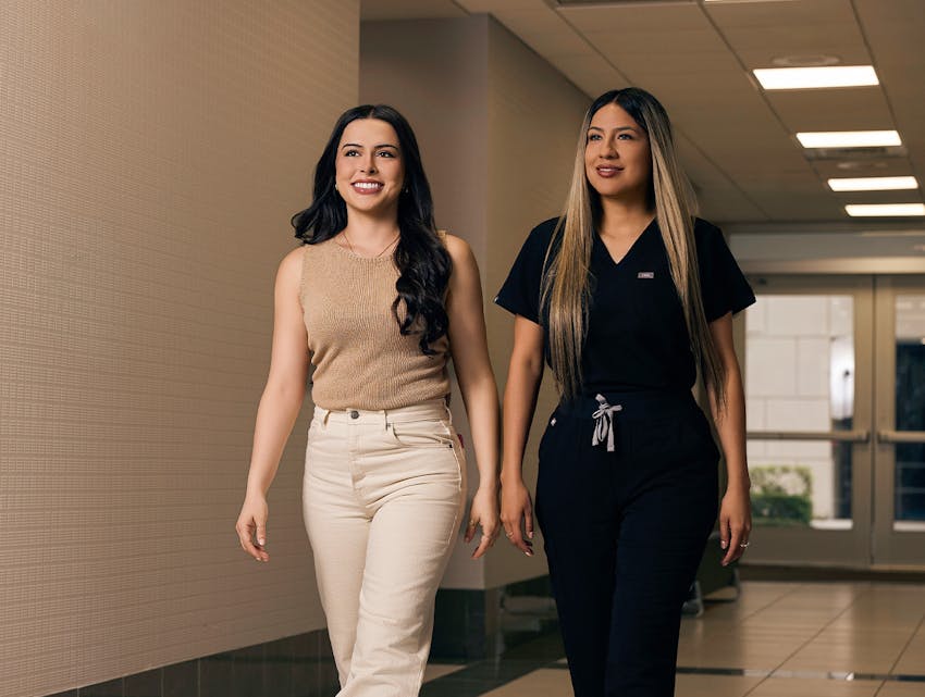 two women walking down a hall