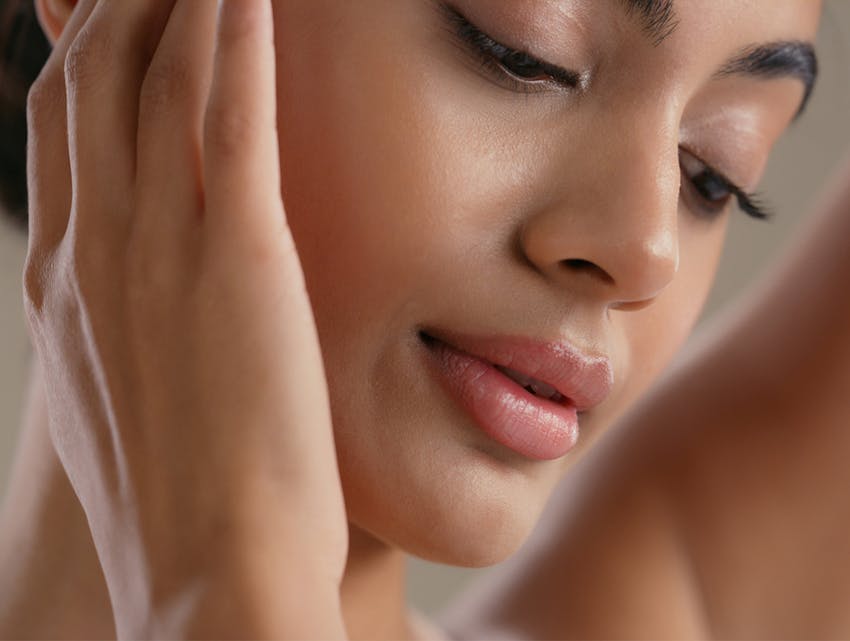 woman touching her face