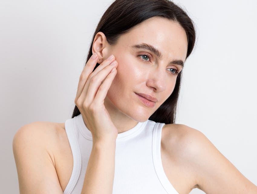 woman touching her face