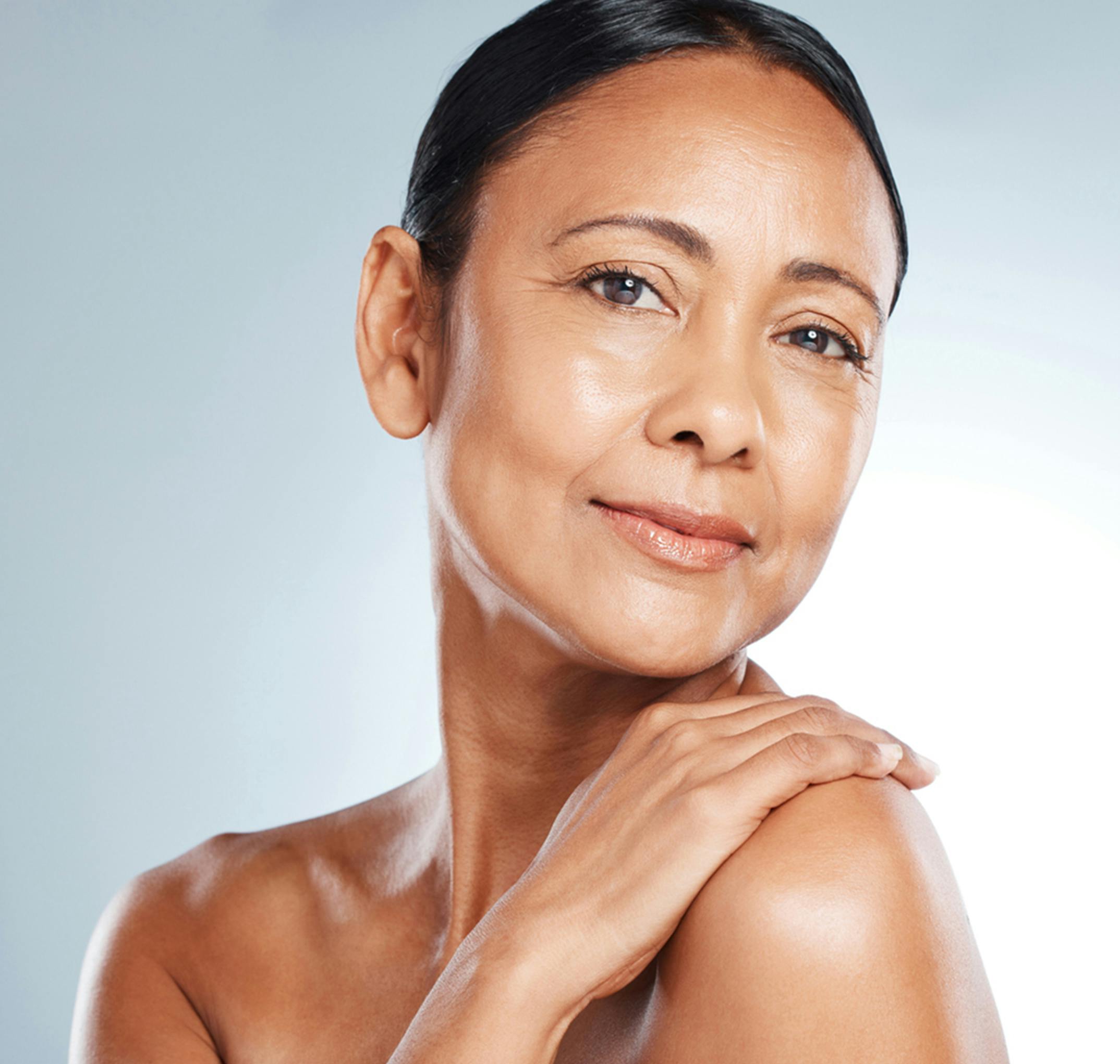 woman touching her shoulder